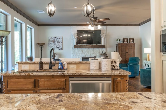 kitchen with stainless steel dishwasher, ornamental molding, a fireplace, and sink