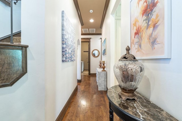 hall featuring ornamental molding and dark wood-type flooring