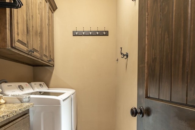 laundry area featuring cabinets and washing machine and clothes dryer