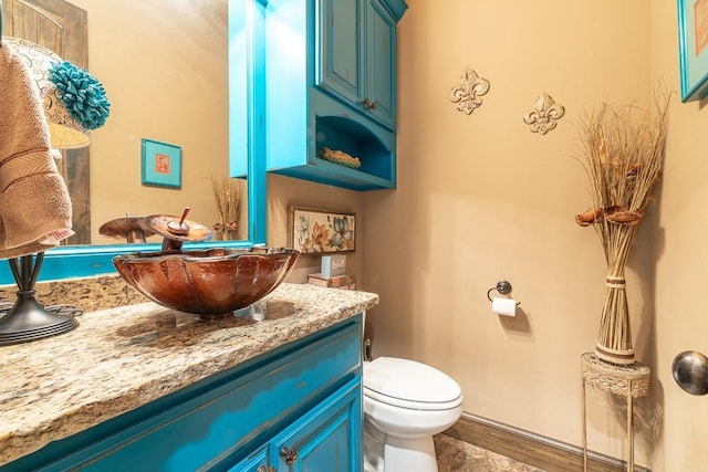 bathroom featuring vanity, hardwood / wood-style floors, and toilet