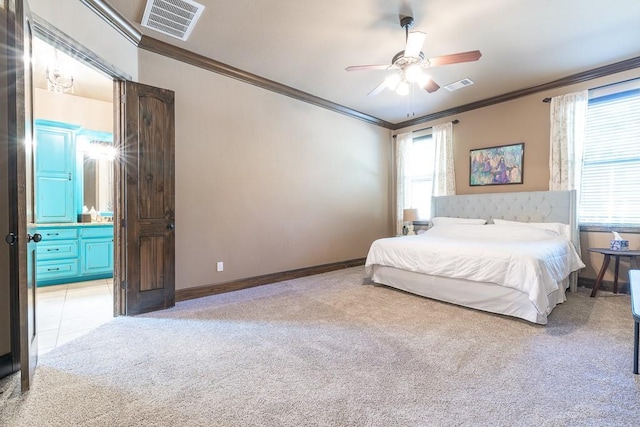 carpeted bedroom with crown molding, ensuite bathroom, and ceiling fan