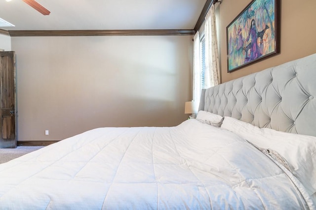 bedroom featuring crown molding, ceiling fan, and carpet