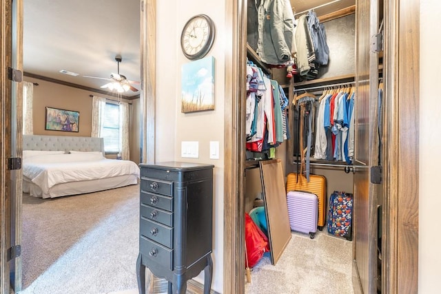 bedroom featuring light colored carpet, ornamental molding, and a closet