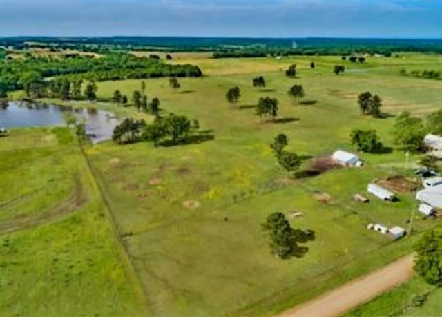 birds eye view of property featuring a rural view and a water view