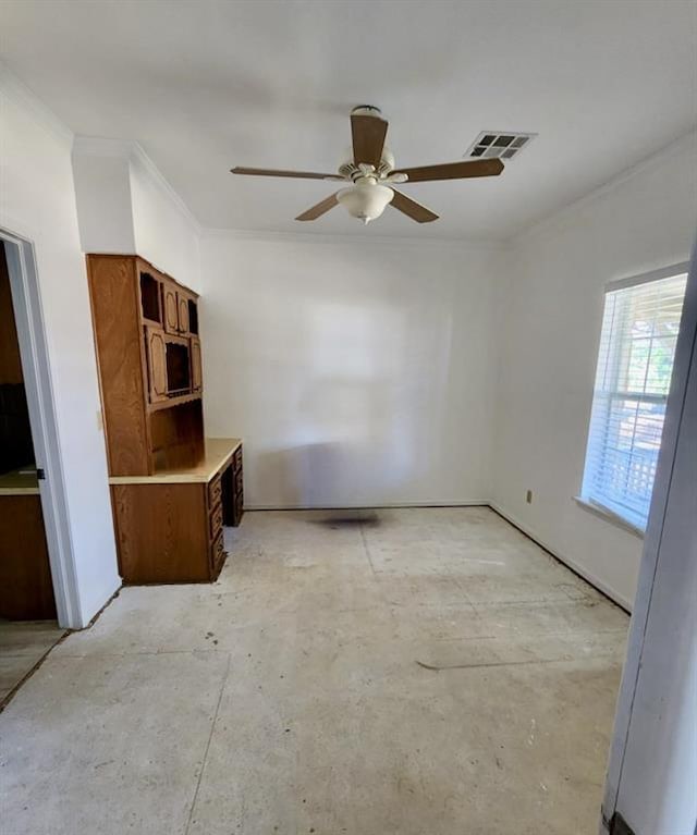 unfurnished room with ornamental molding and ceiling fan