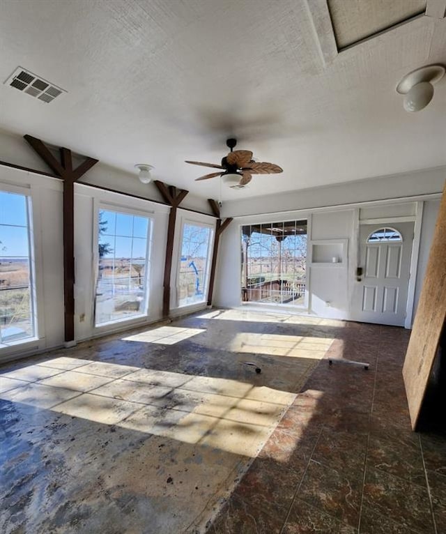 interior space with plenty of natural light and ceiling fan