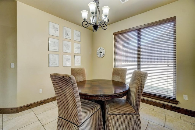 dining area featuring a chandelier and light tile patterned floors