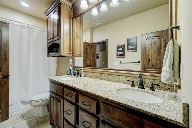 bathroom with vanity, tile patterned floors, and toilet