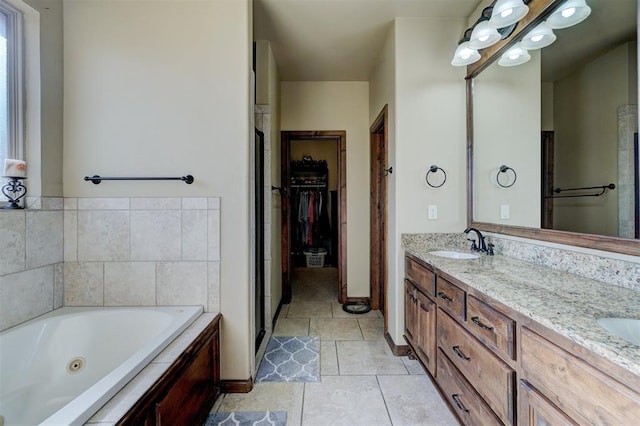 bathroom with tile patterned flooring, vanity, and a bathtub