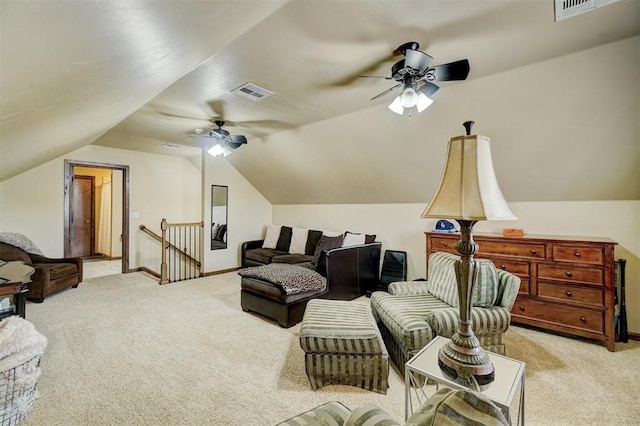 sitting room with ceiling fan, lofted ceiling, and light carpet