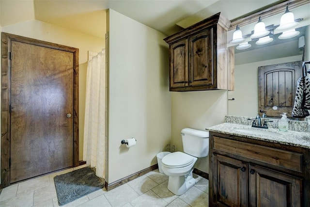 bathroom with vanity, tile patterned flooring, and toilet