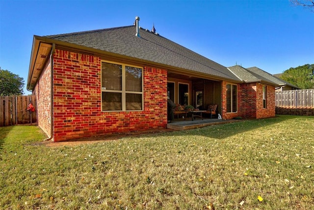 back of property featuring a yard and a patio