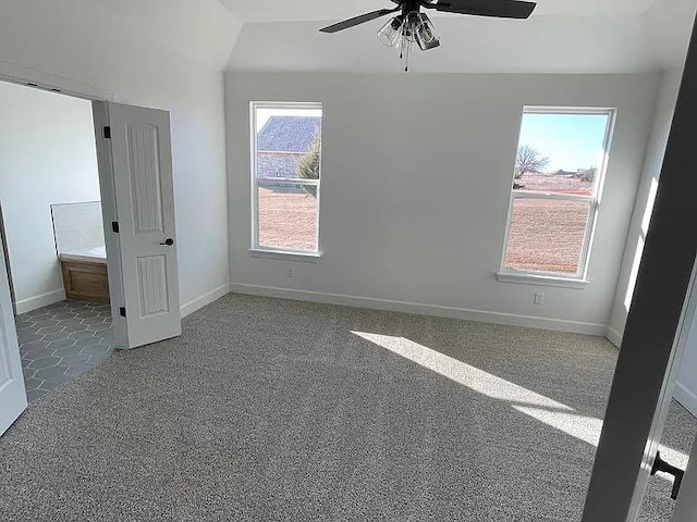 carpeted empty room featuring ceiling fan