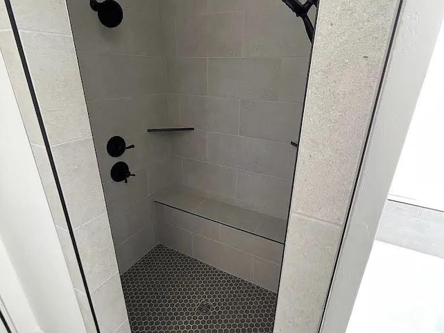 bathroom with a tile shower