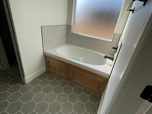 bathroom featuring tile patterned floors and a tub