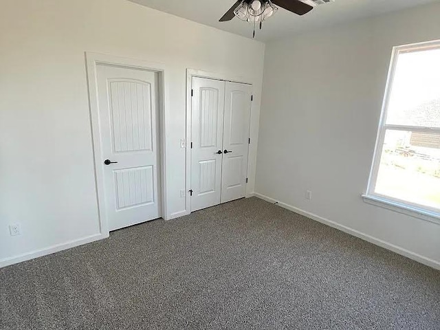 unfurnished bedroom with ceiling fan and carpet flooring