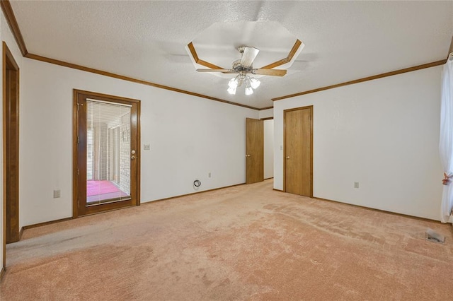 unfurnished bedroom with ornamental molding, light carpet, ceiling fan, and a textured ceiling