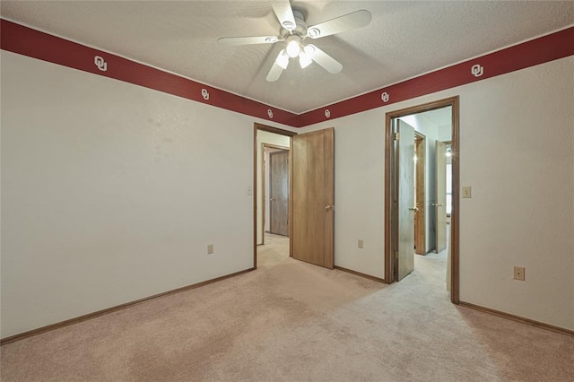 unfurnished bedroom featuring light carpet, ceiling fan, and a textured ceiling