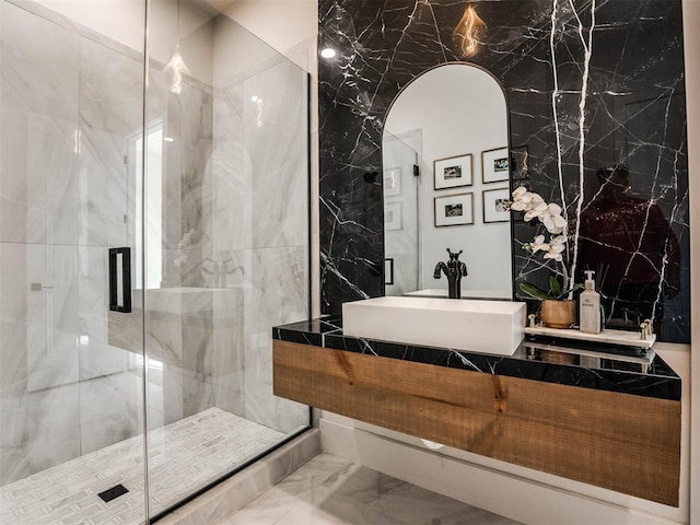 bathroom with sink, tile walls, and an enclosed shower