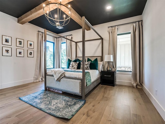 bedroom featuring beamed ceiling, a chandelier, and light hardwood / wood-style floors