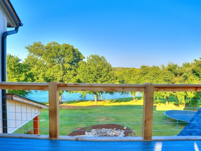 deck with a trampoline and a yard