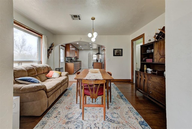 dining area featuring dark wood-type flooring