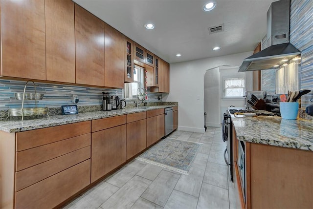 kitchen featuring sink, tasteful backsplash, stainless steel dishwasher, light stone countertops, and range hood