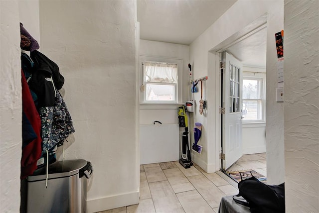 foyer entrance featuring a healthy amount of sunlight and light tile patterned floors