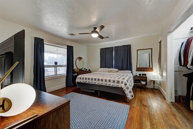 bedroom with ceiling fan and wood-type flooring