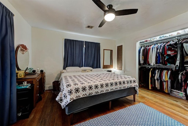 bedroom featuring hardwood / wood-style floors, a closet, and ceiling fan