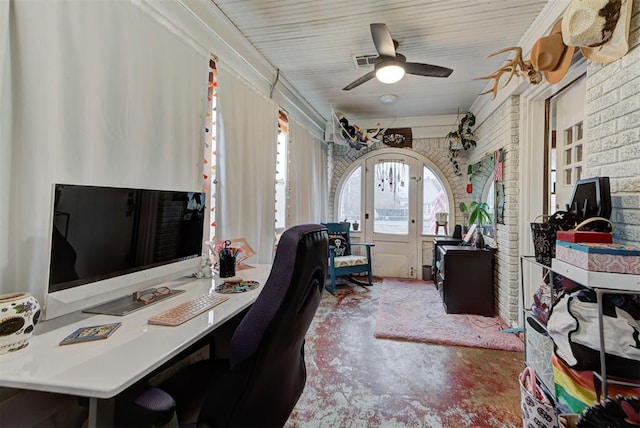 office featuring brick wall, concrete floors, ceiling fan, and french doors