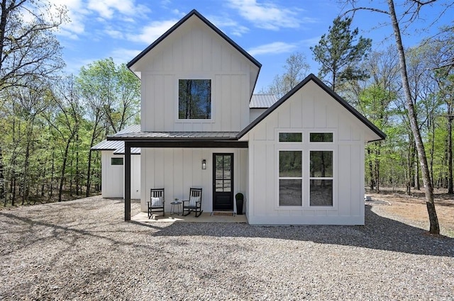 rear view of property with covered porch