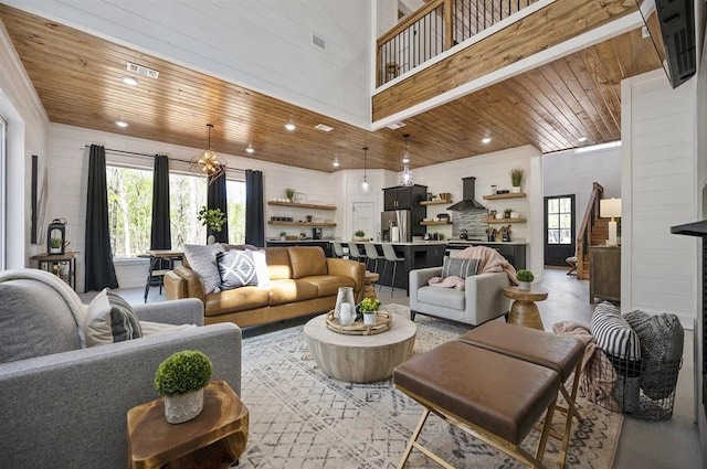 living room with wood ceiling and a high ceiling