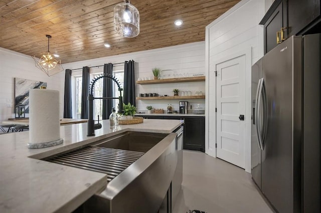 kitchen with stainless steel fridge with ice dispenser, sink, hanging light fixtures, light stone counters, and wood ceiling