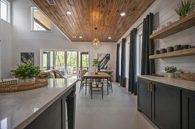 dining space featuring a wealth of natural light and wood ceiling