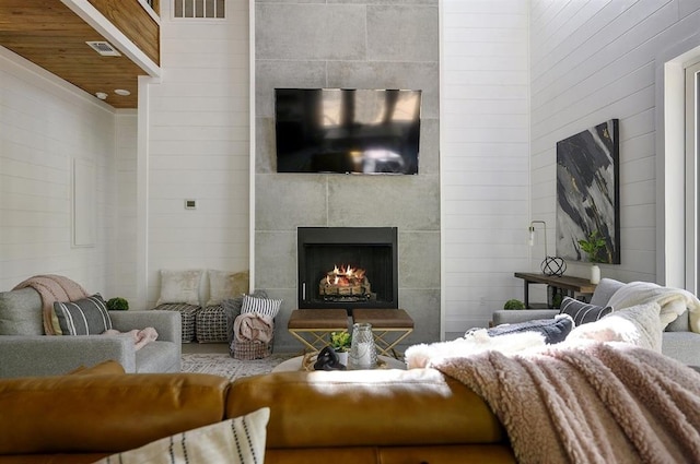 living room with a tiled fireplace