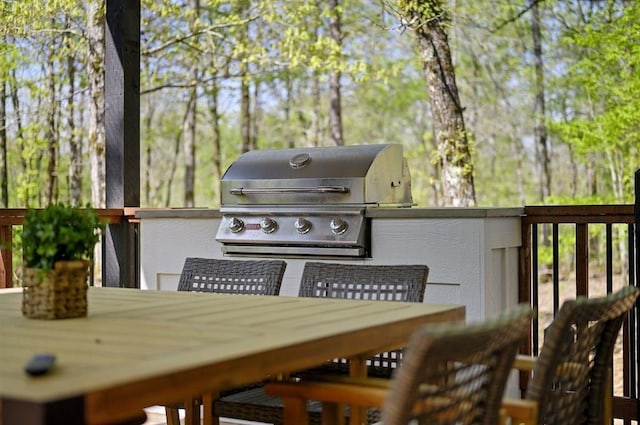 deck with an outdoor kitchen and area for grilling