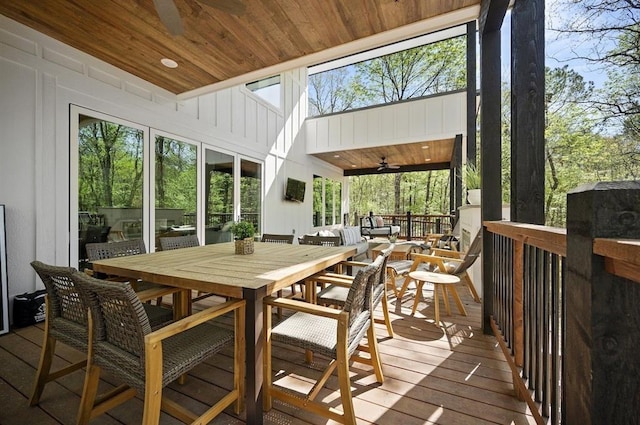 sunroom featuring wood ceiling and ceiling fan