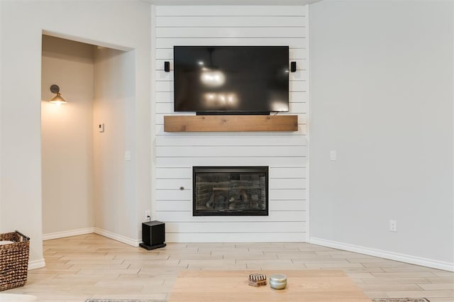 unfurnished living room featuring wood-type flooring and a fireplace