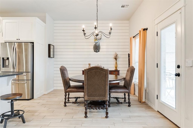 dining space featuring a notable chandelier and light hardwood / wood-style flooring