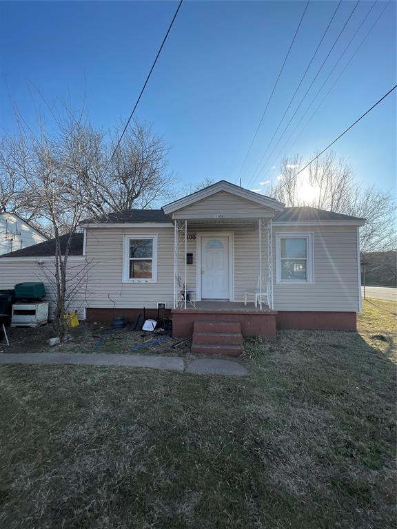 view of front of home with a porch and a front yard