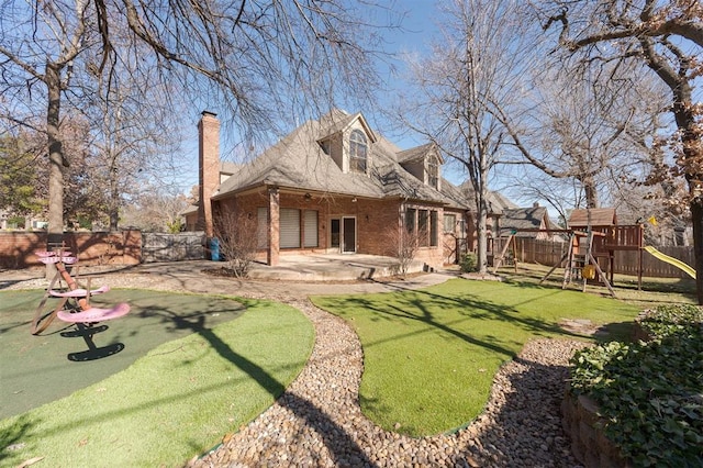 back of property with a playground, a yard, and a patio area