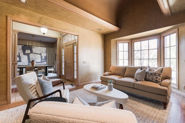 living room with beamed ceiling, plenty of natural light, and light hardwood / wood-style floors