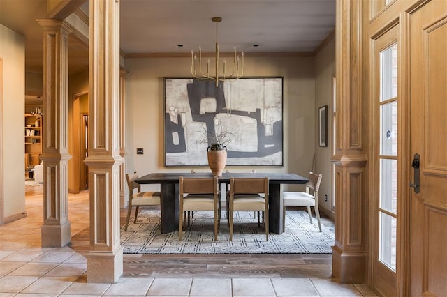 tiled dining area with an inviting chandelier, crown molding, and ornate columns