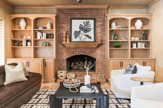 living room featuring ornamental molding, a fireplace, and light hardwood / wood-style flooring