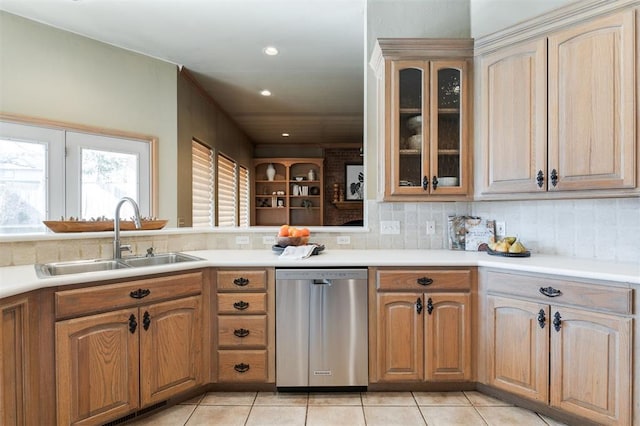 kitchen with tasteful backsplash, dishwasher, sink, and light tile patterned floors