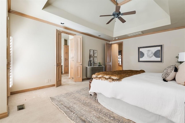 carpeted bedroom featuring crown molding and a raised ceiling