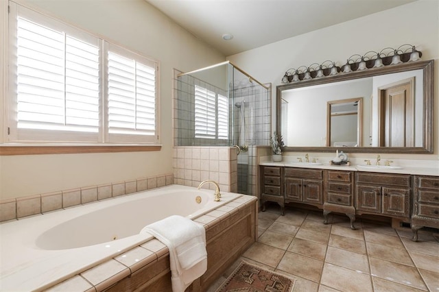 bathroom with tile patterned floors, vanity, and shower with separate bathtub