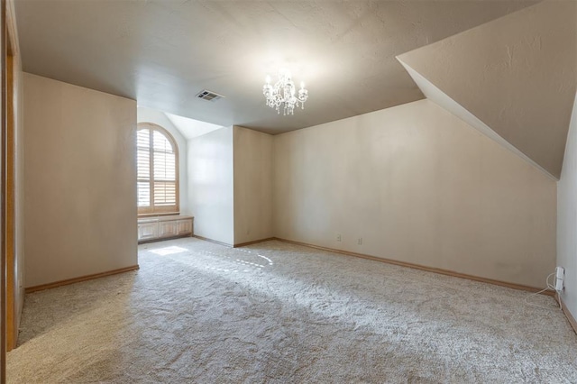 additional living space featuring light colored carpet and an inviting chandelier