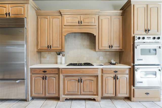 kitchen featuring black gas cooktop, double wall oven, light countertops, stainless steel built in fridge, and tasteful backsplash